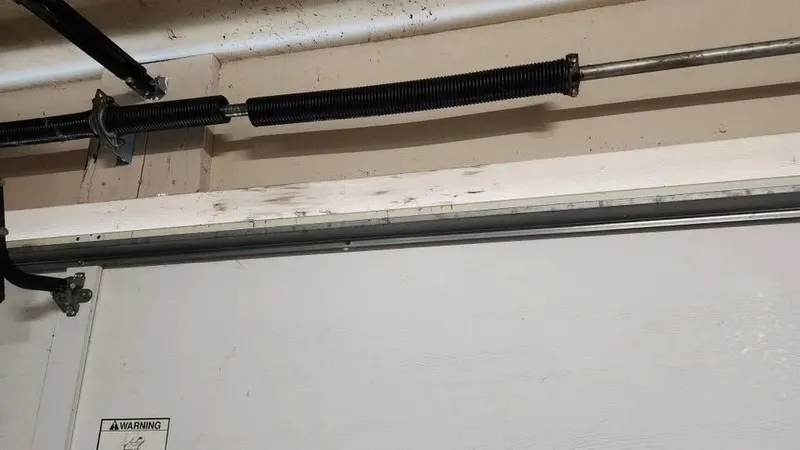 Torsion springs mounted on the shaft above a garage door